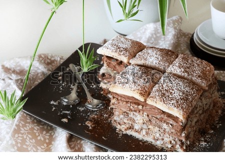 Delicious millefeuille dessert with chocolate cream isolated on white background. Overhead view. Copy space.