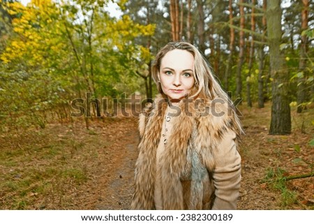Women at a barbecue in the autumn forest, taking pictures in the autumn leaves.