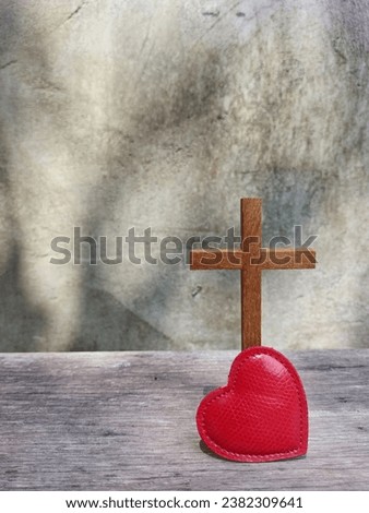 Jesus cross, red heart on wooden plank with leaf shadow  on cement wall as background. Jesus love you. Jesus die for you. Faith hope Believe salvation  Christianity concept