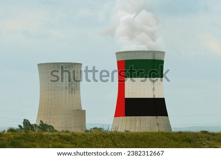 The UAE flag is displayed on the cooling tower of the nuclear power plant. Royalty-Free Stock Photo #2382312667