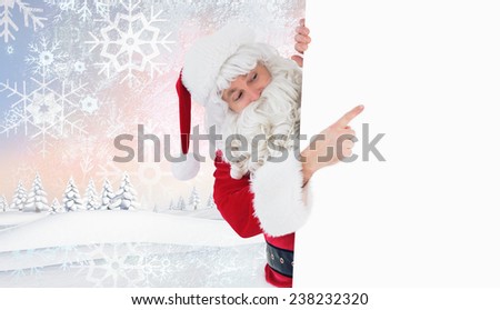 Festive father christmas presenting sign against snowy landscape with fir trees