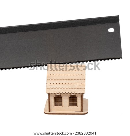 Close-up of a sharp saw for woodworking and cutting a wooden toy house. Conceptual image. Isolated on white background.