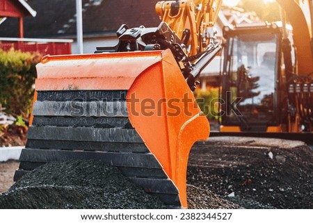 Modern Construction Machinery in Action. Construction of a road. Earth movement. Big excavator doing work on the construction of a road.