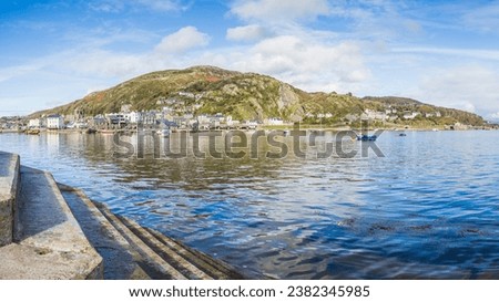 A multi image panorama of Barmouth harbour pictured from the pier at low tide in October 2023.