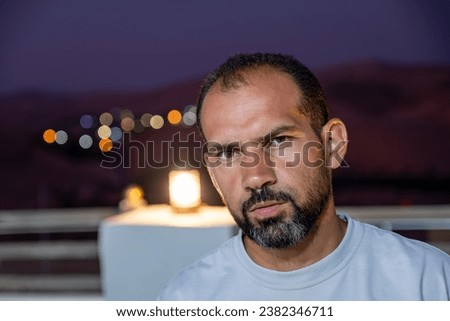 portrait for middle age male wearing white t-shirts with blurred lights background