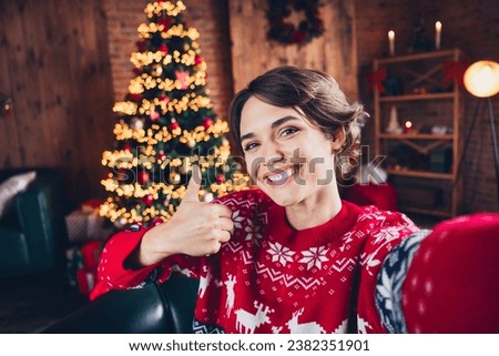 Selfie of toothy smiling girl young age vlog lifestyle buy gifts for miracle merry christmas thumb up isolated home interior background