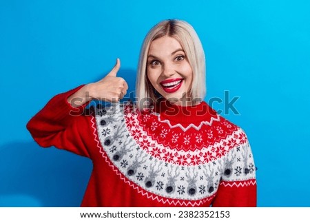 Photo of excited positive girl enjoy christmas discounts make thumb up symbol isolated blue color background