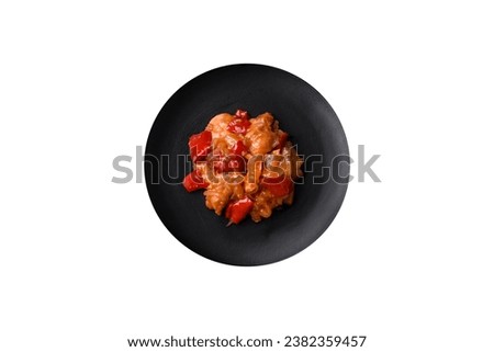 Delicious fresh salad with slices of grilled chicken, pineapple, sweet pepper, nuts and sauce on a ceramic plate on a dark concrete background Royalty-Free Stock Photo #2382359457