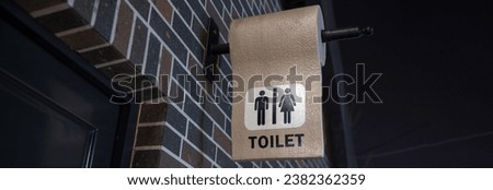 Man and lady toilet sign on concrete wall background
