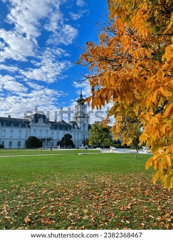 Stunning view of famous palace Festetics-Palast and a tree with golden yellow leaves in Keszthely, Hungary Royalty-Free Stock Photo #2382368467