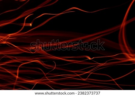 light ribbons of sparks on a black background, long exposure