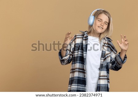 Teen girl in headphones looking enjoyed while listening to music