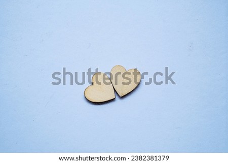 Two wooden heart on white surface
