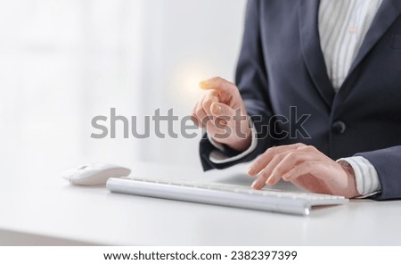 Business asian female professionals worker using computer keyboard diving into digital tasks, showcasing dedication and finesse, all from their workstations, cloud computing. Royalty-Free Stock Photo #2382397399