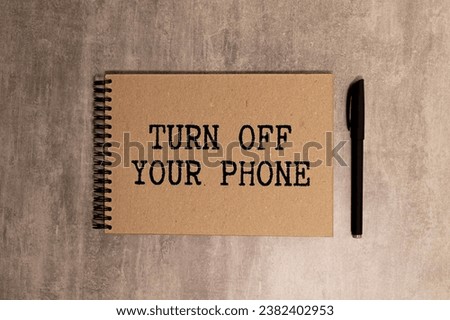 Business man pointing the text Turn Off Your Phone Royalty-Free Stock Photo #2382402953