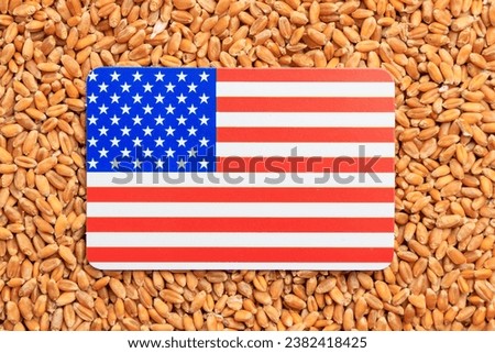 USA flag on a background of wheat grain. Concept of grain deal and world food security. Texture or backdrop
