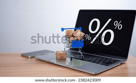 Sale percentage with shopping cart and boxes placed on computer keyboard. Online shopping concept, special price products, Special offers and promotions Royalty-Free Stock Photo #2382423009