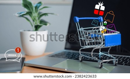 Shopping cart and gift box icons placed on laptop computer represent  online shopping concept, website, e-commerce, market platform, technology, , shipping, logistics and online payment concept.