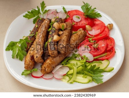 A plate of food with meat sausages and green vegetables salad
