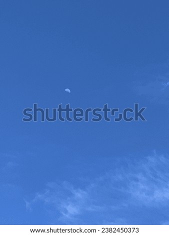 The moon and the sky belong together. Even though during the day you can barely see it. But at least it lets us know that the existence of the moon is real even if it's not at night. Royalty-Free Stock Photo #2382450373