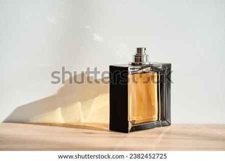 A bottle of perfume in the rays of the sun.