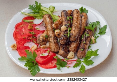 A delicious platter of food with meat sausages and green vegetables salad