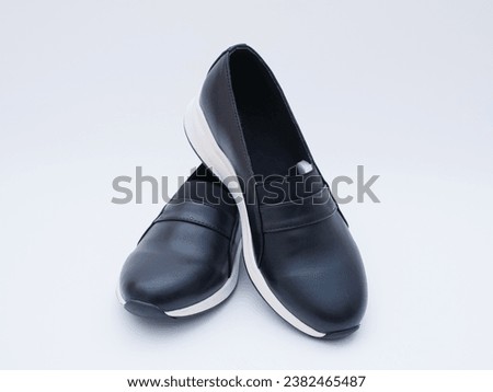 a pair of women's black casual loafers Royalty-Free Stock Photo #2382465487