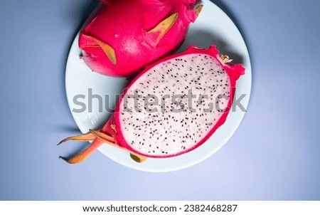 Dragon fruit on blue background close up with copy space. 