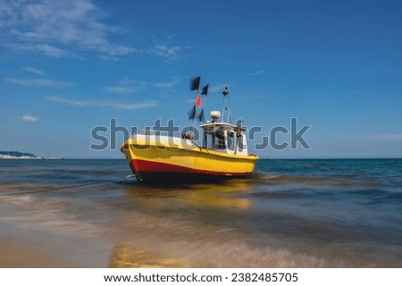Fishing boat on the beach in Sopot, Poland. Magnificent long exposure calm Baltic Sea. Wallpaper defocused waves. Fishermans sea bay Vacation and holidays. travel attraction