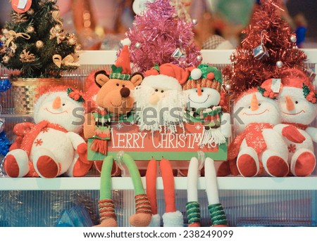 Merry Christmas - Santa and snow dolls sitting on shelf together