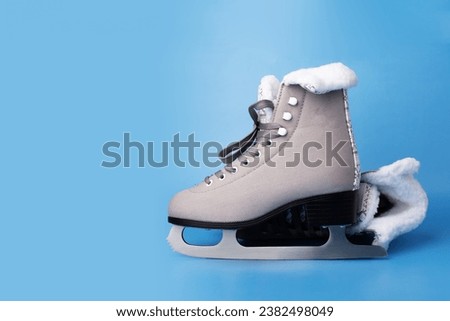 Sporty ice skates on blue, perfect for the rink, Training equipment Royalty-Free Stock Photo #2382498049