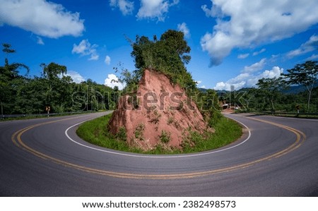 The road curves like the number zero or 0. This road is built on a mountain, past the forest in Nan Province of Thailand. The road loops like zero, Good scenery and have tourists to take pictures.