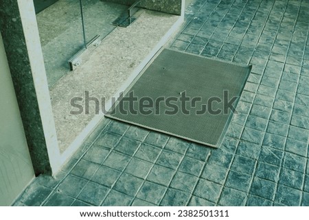 Gray soft carpet before the door at restaurant,doormat on floor,copy space for text,Home interior design.