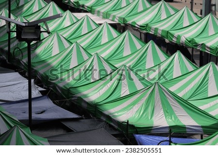 Canvas tents are set up outdoors , Flea market tents in Thailand Royalty-Free Stock Photo #2382505551