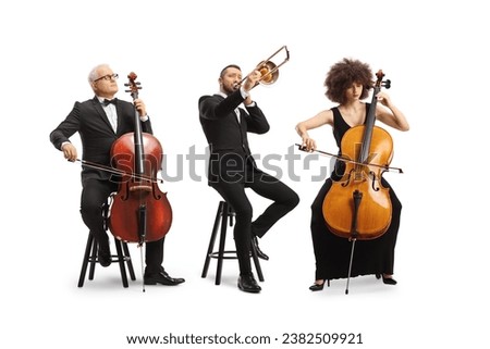 Full length portrait of musicians sitting and playing cellos and a trombone isolated on white background