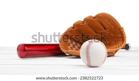 Baseball bat, ball and catcher's mitt on wooden table against white background