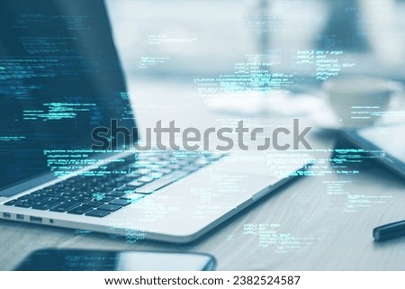 Close up of laptop on desk with supplies and creative coding html language on blurry background. Web developer and programming concept. Double exposure