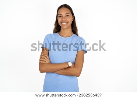 Dreamy rest relaxed Young beautiful woman wearing blue T-shirt crossing arms, Royalty-Free Stock Photo #2382536439
