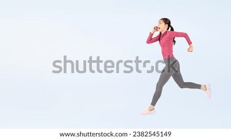 Asian woman wearing sportswear running energetically. Wide angle visual for banners or advertisements.