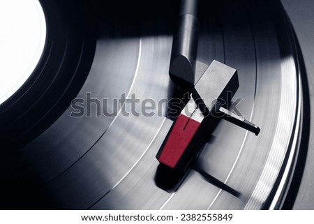 Turntable plays vinyl, high contrast and motion blur Royalty-Free Stock Photo #2382555849