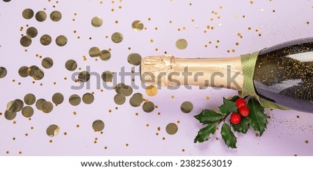 Champagne bottle with confetti on violet background. Christmas, birthday or wedding concept. Flat lay. Panorama.