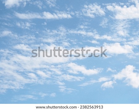 Clouds scudding across a bright blue sky.