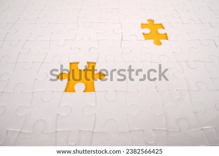 White details of the puzzle on a yellow background. White jigsaw puzzle.