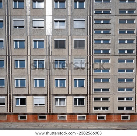 Facade of the socialistic panel grey with orange old building with windows in Berlin, Germany Royalty-Free Stock Photo #2382566903
