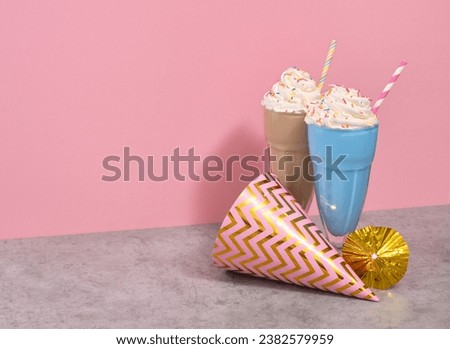 Image of cheerful birthday. Festive colorful hat, cocktail umbrella and milkshakes with colored sprinkles and straws. Copy space for text.