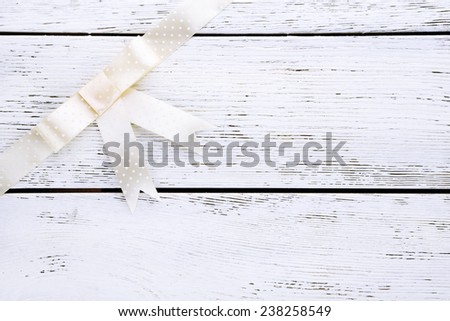 Old wooden background with beautiful bow
