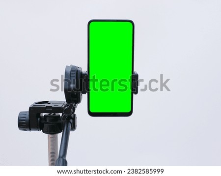 smartphone with green screen on tripod holder. smartphone mock up with chroma key