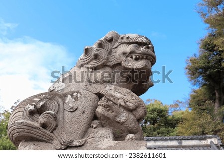A guardian dog guarding the entrance to a Japanese shrine Royalty-Free Stock Photo #2382611601