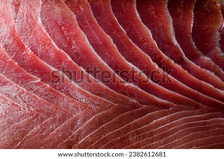 Appetizing fresh sliced bluefin tuna raw meat texture. Close-up. Macro photo. Fish fillet texture as wallpaper Royalty-Free Stock Photo #2382612681