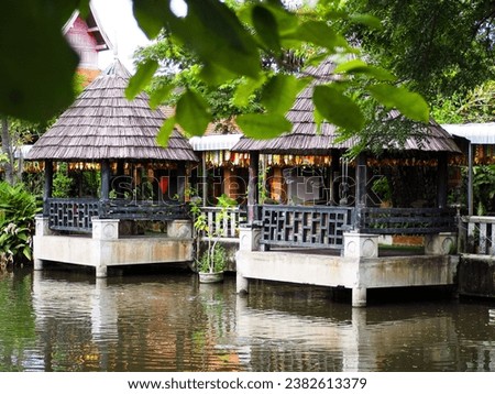 A pavilion built next to a pond for sitting and relaxing.